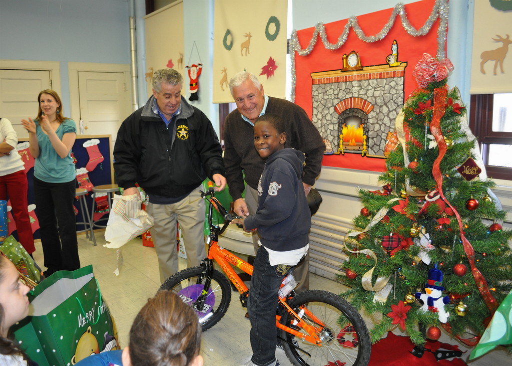  

14th Avenue School honor roll student Karoon Boundarrant is all smiles after receiving a bicycle from Sheriff Armando Fontoura and businessman Joseph Farina as part of the 20th annual Essex County Sheriff’s Holiday Toy Drive for Needy Children.